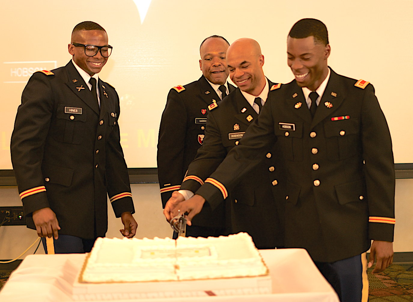 Second Lt. Christopher Hines and 2nd Lt. Antoine M. Hobson cut the ceremonial cake in their honor. They’re joined by keynote speaker Col. Rodney Harris of the Mississippi Army National Guard, and Maj. Steven Robinson, department chair and professor of Military Science in JSU’s College of Business. (Photo by Desmond Jones/JSU ROTC)