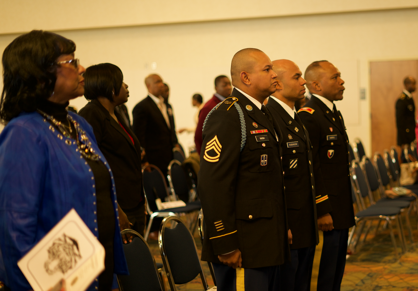 Military officers and the audience join in the presentation of the colors and the national anthem. (Photo by Desmond Jones/JSU ROTC)