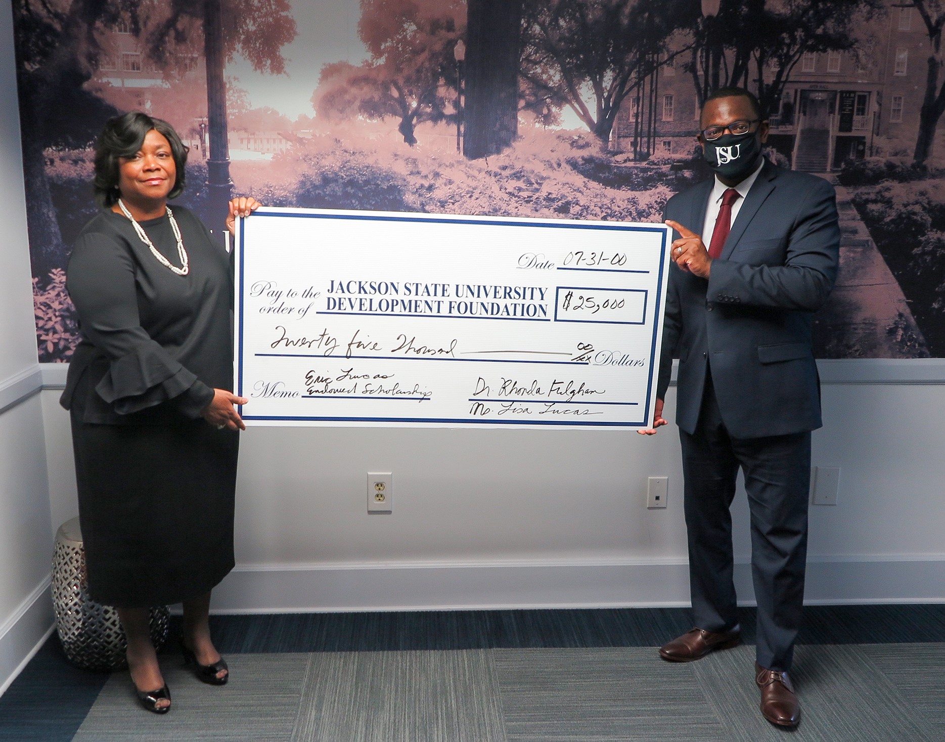 Acting president Thomas Hudson accepts a $25,000 pledge from retired JSU professor Dr. Rhonda Fulgham. Fulgham spent 30 years at the university teaching economics. (Photo by Rachel James-Terry/JSU)