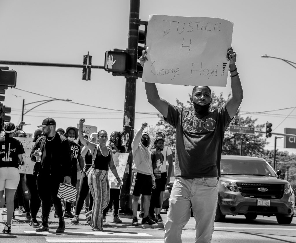 Christopher Calhoun, a rising junior at JSU, joins the Chicago-based march and displays his position in the social justice movement. (Photo by Wakil Atig)