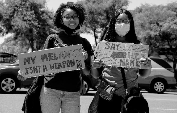 Two attendees show that melanin matters while pausing for a photo. (Photo by Wakil Atig)