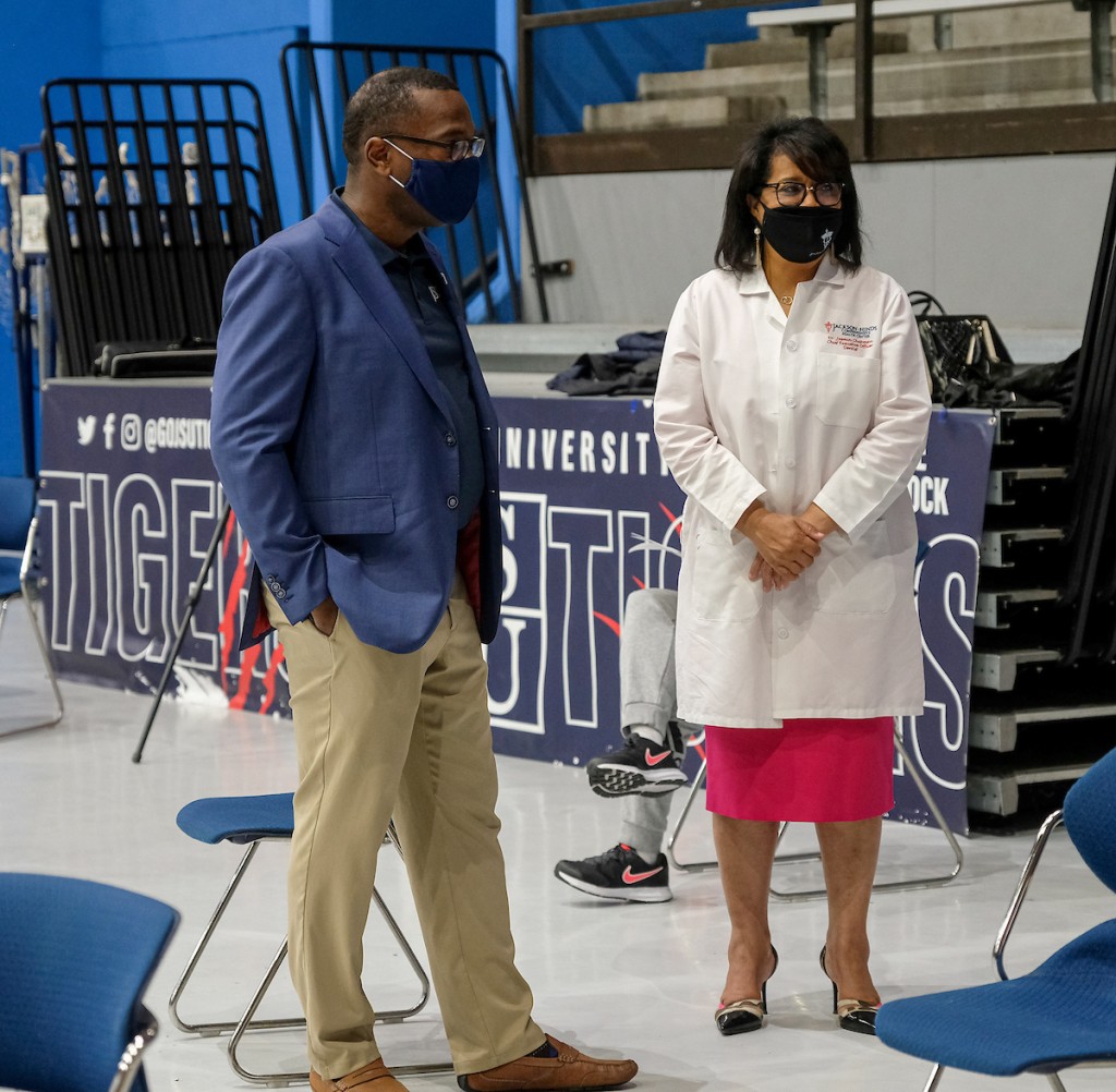 JSU President Thomas Hudson and Dr. Juanita Chapman, chief executive officer of the Jackson-Hinds Comprehensive Health Center, observe the vaccination site as students, faculty and staff file into the Lee E. Williams Athletics and Assembly Center. (Photo by Charles A. Smith/JSU)