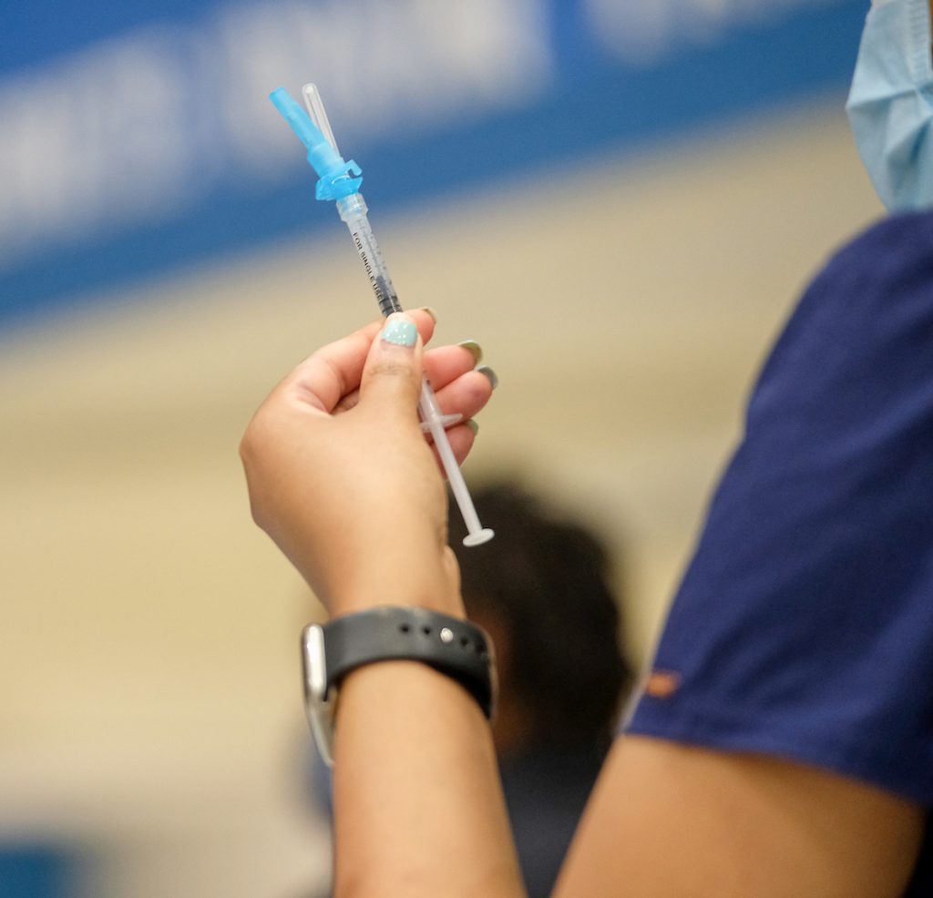 A nurse prepares a syring for her next patient. (Photo by Charles A. Smith/JSU)