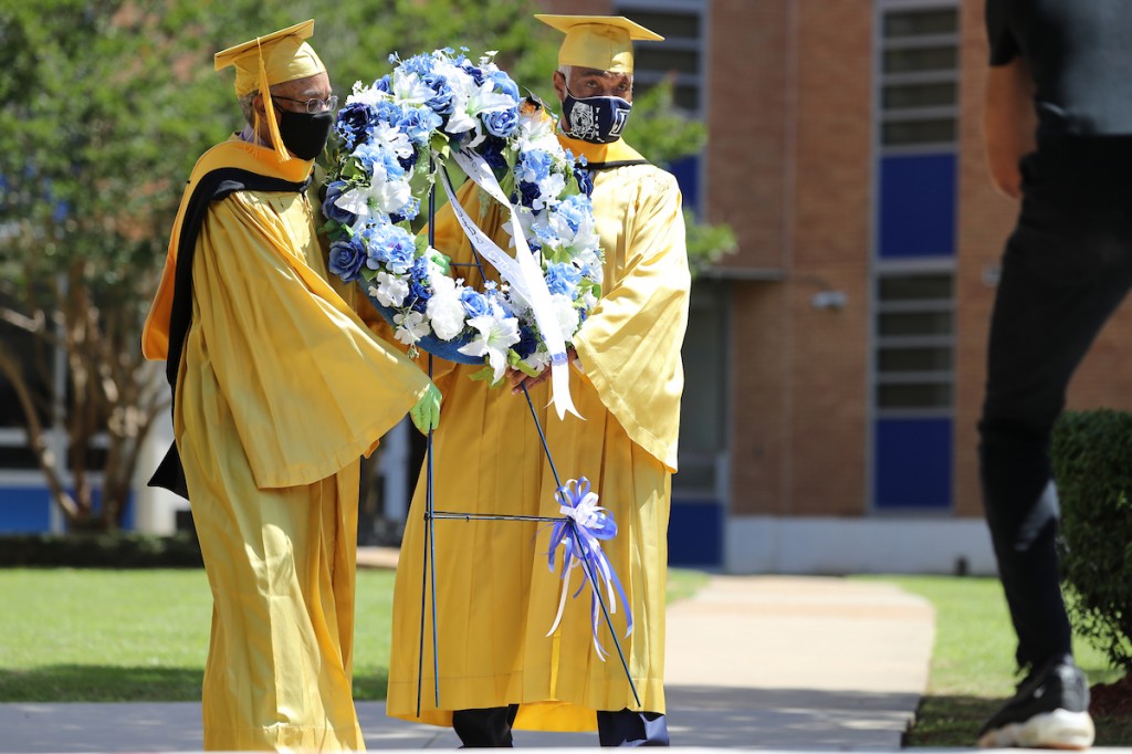 Baker and classmate Quilly Turner lay a memorial wreath at Alexander Hall. (Photo by Charles A. Smith/JSU)