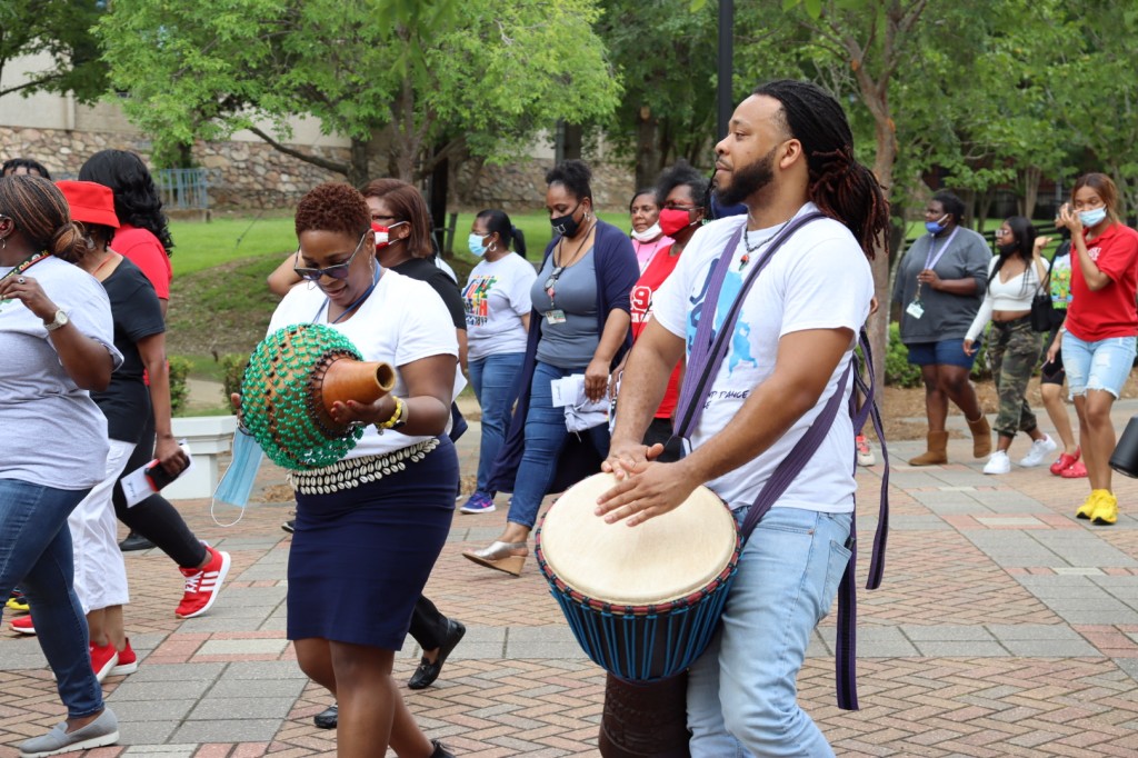 Marching to the beat of drums and other sounds, participants roll through the campus in observance of Juneteenth. Dr. Lisa M. Beckley-Roberts, chair and associate professor of Ethnomusicology in the Department of Music, plays the shekere. She’s joined by Shawn Lawrence, playing the djembe. (Photo by Ryan Lowe/Special to JSU)