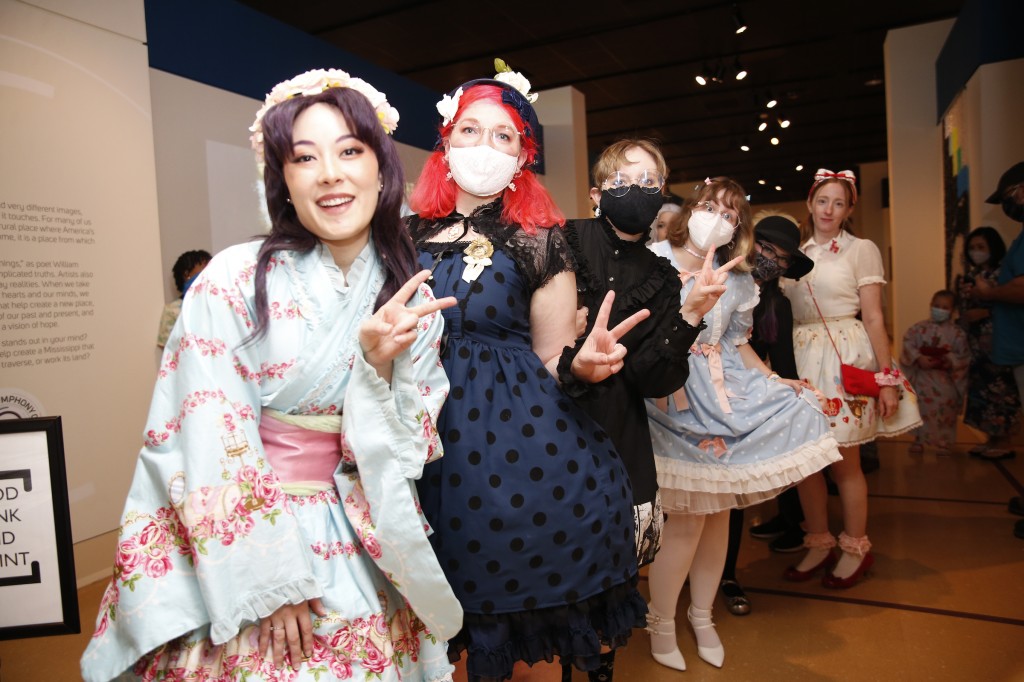 Models are all peace and love right before they strut across the make-shift stage to show hoff their Asian and cosplay fashions. (Photo by Aron Smith)