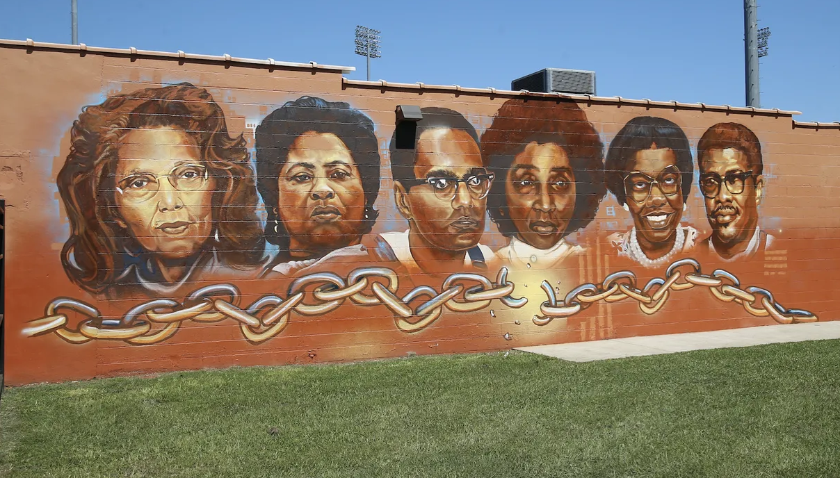 The painting, titled "Chain Breakers" is located on the outside of the Council of Federated Organizations (COFO) building.