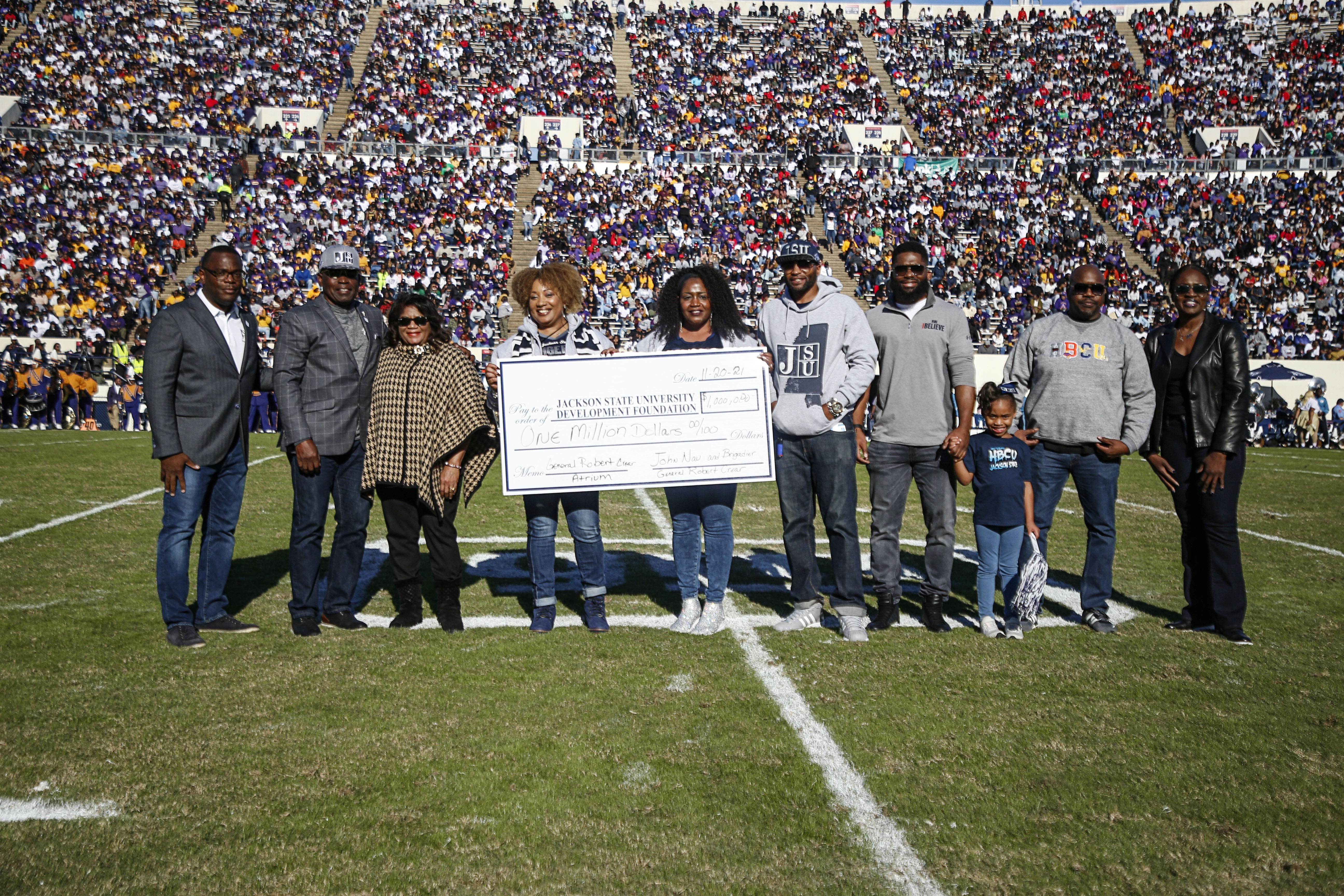 JSU President Thomas K. Hudson poses for a photo with Brig. Gen. (Ret.) Robert Crear, his family and Gee Johnson, board chairwoman of the JSU Development Foundation, Inc., as Crear presents JSU with a big check for $1 million from his colleague John Nau, president and CEO of Silver Eagle Distributors, L.P.