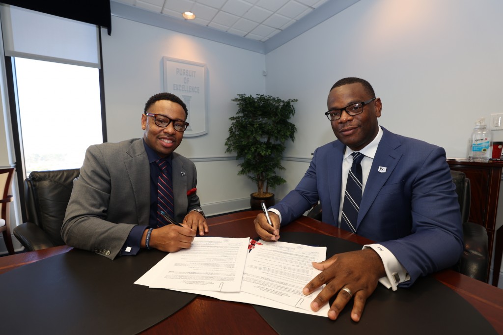 Jackson State University President Thomas K. Hudson, J.D., and Vice President and Athletic Director Ashley Robinson solidify Robinson's contract extension through 2026. Under Robinson’s leadership, JSU's student-athletes have excelled in their respective sports and the classroom.