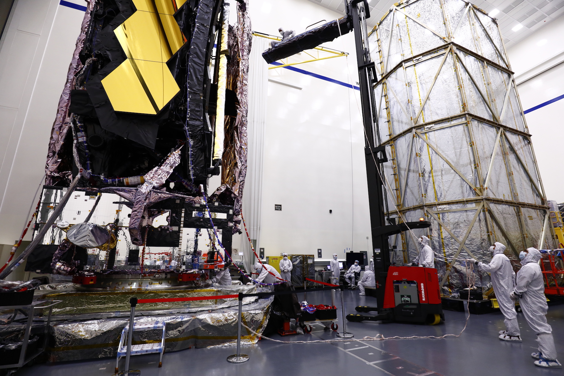 Balancing on a lift, Douglas Williams II moves into position to begin an operation to remove Photogrammetry targets from the telescope before it could begin space environmental testing. (Photo courtesy of Northop Grumman)
