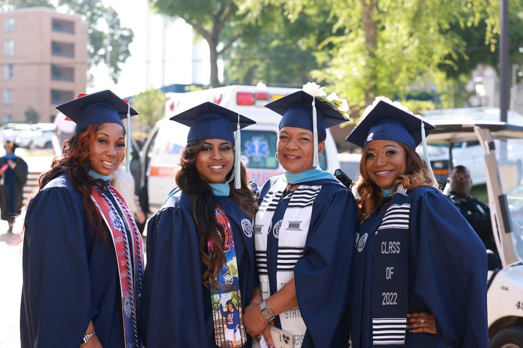 Ameshia Bacon and Jacqueline Bacon-Hill (center) are a aunt and niece duo who both received a master's degree in teaching. Bacon shared how it was good to have her aunt attend JSU with her because the two supported each other throughout their educational journey. (Photo by William A. Kelly/JSU)