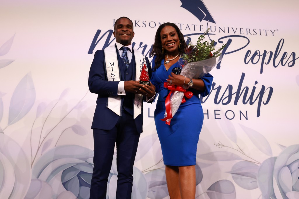 Mister JSU Joshua Evans honors Sheryl Lee Ralph with an award and flowers after her keynote at the university's annual scholarship luncheon. (Photo by Charles A. Smith/JSU)