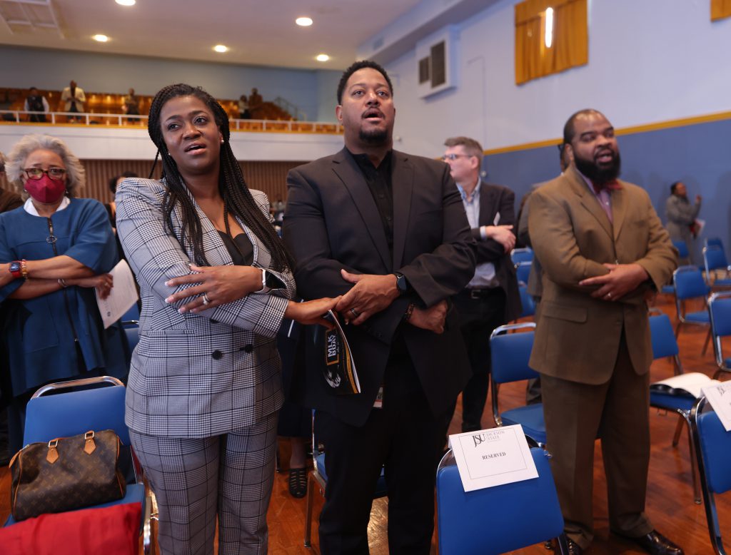 At the end of the program, audience members join hands to sing 'We Shall Overcome'. (Charles A. Smith/University Communications)