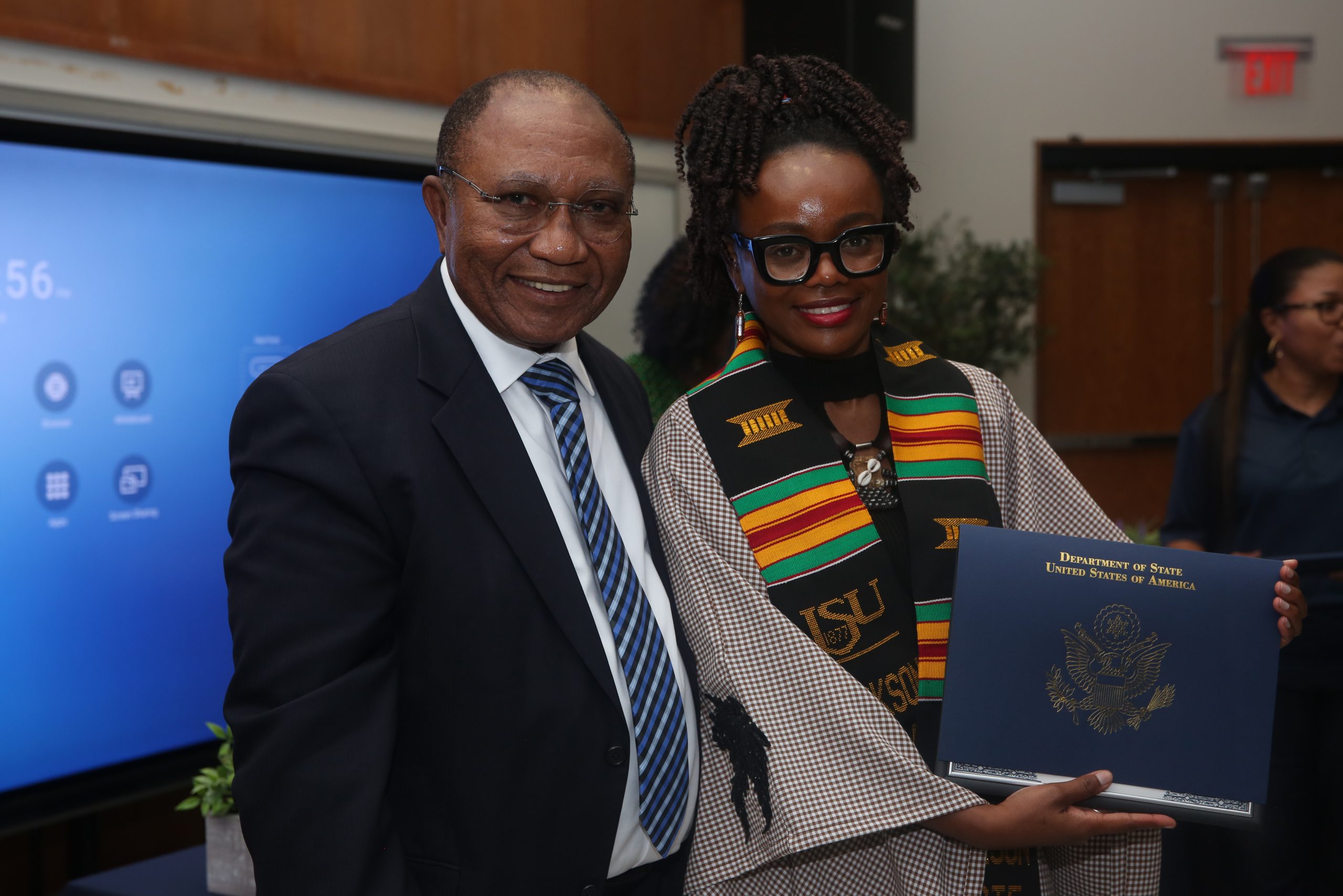 Dean Fidelis Ikem presents certificates of completion to the fellows.