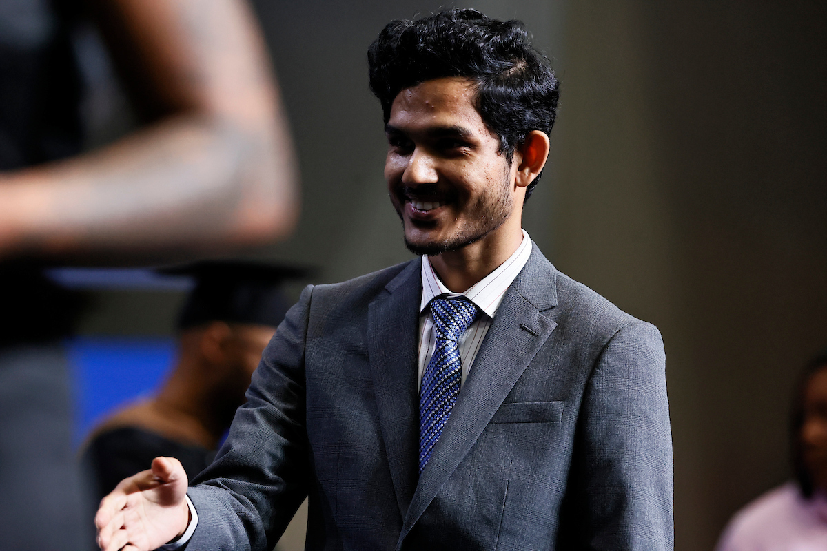 male student shakes hands with JSU leaders