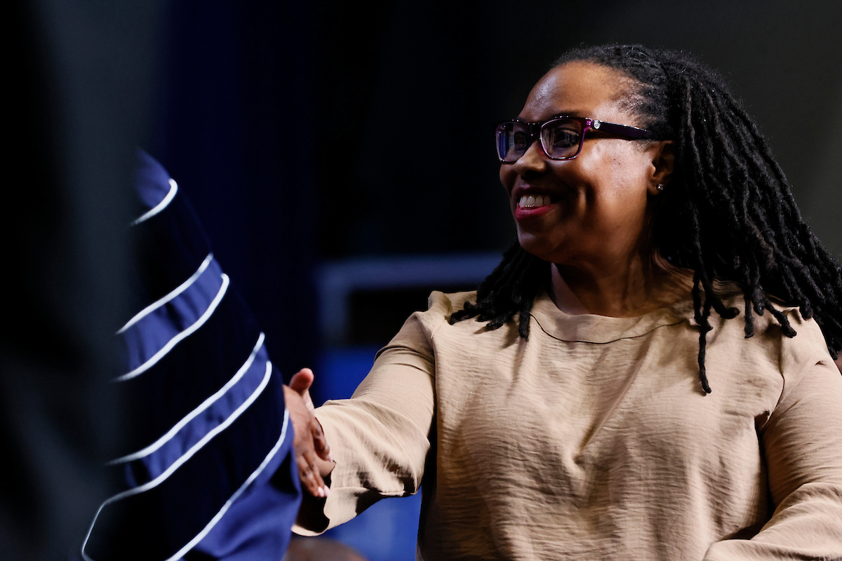 female student shakes hand with jsu leader