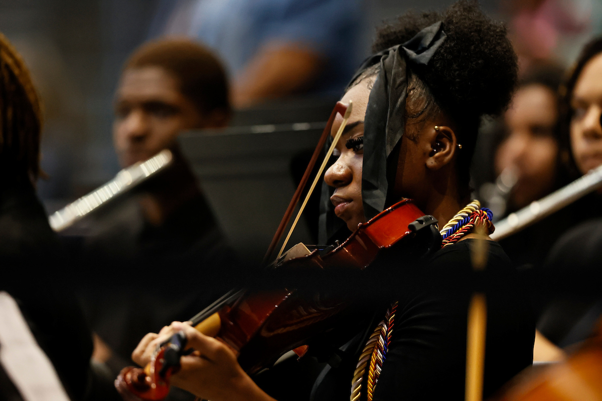 female student plays musical instrument