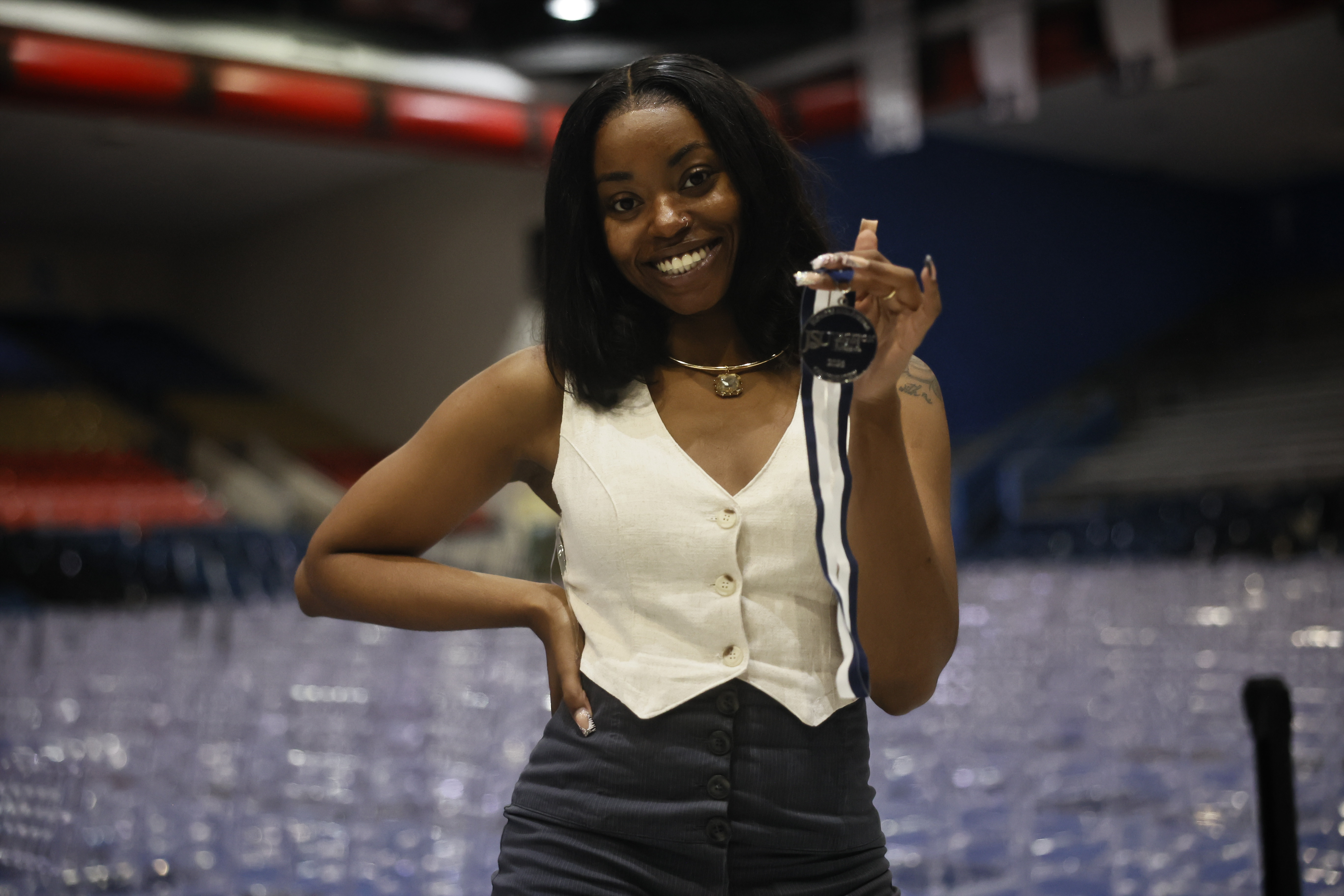 female student smiles with medal