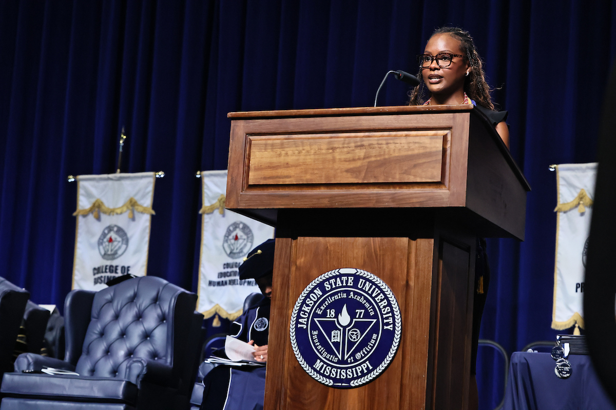 female student speaks at podium