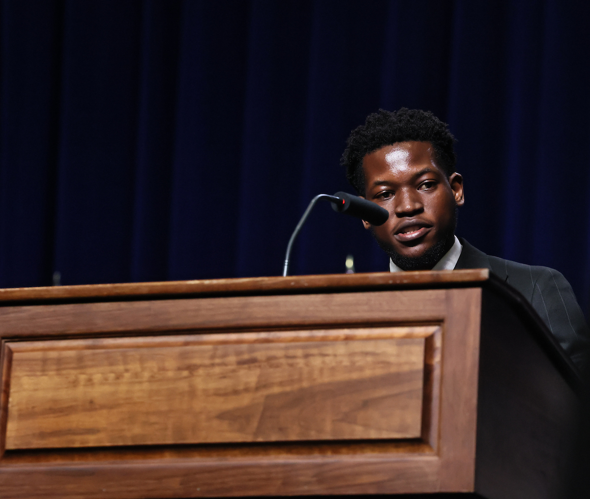 male student speaks at podium