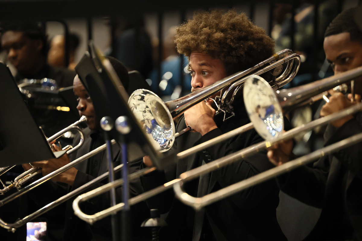 male student plays trumpet
