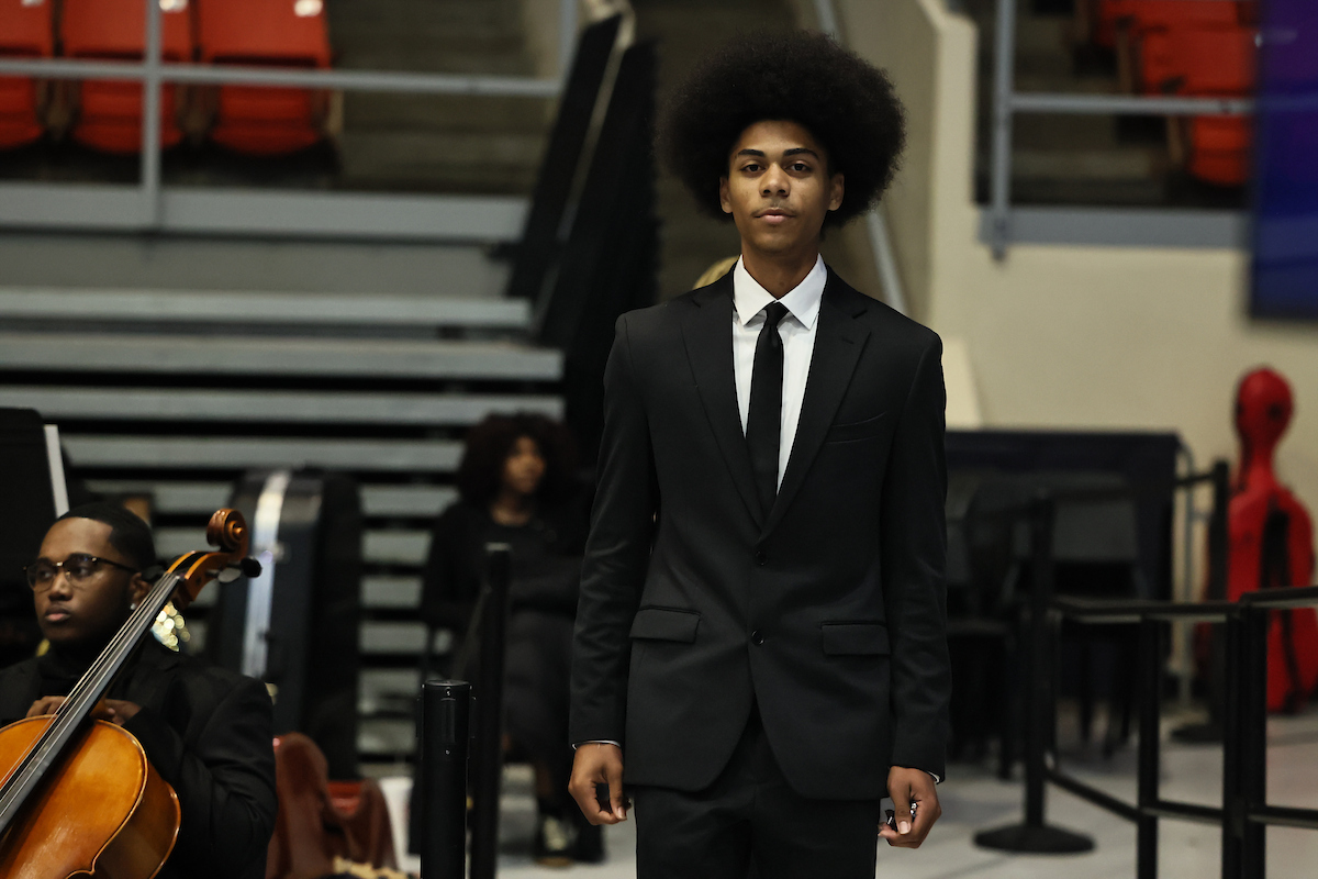 male student walks to podium
