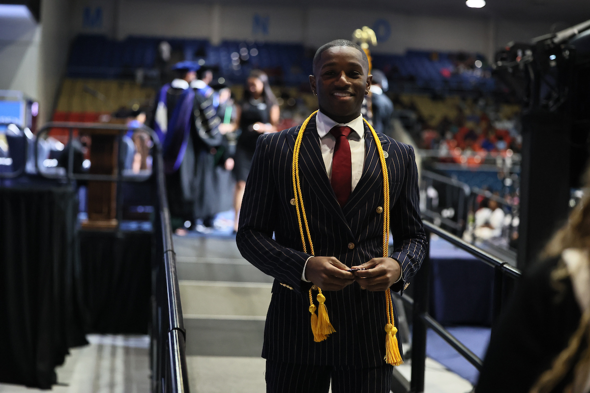 male student smiling with medal