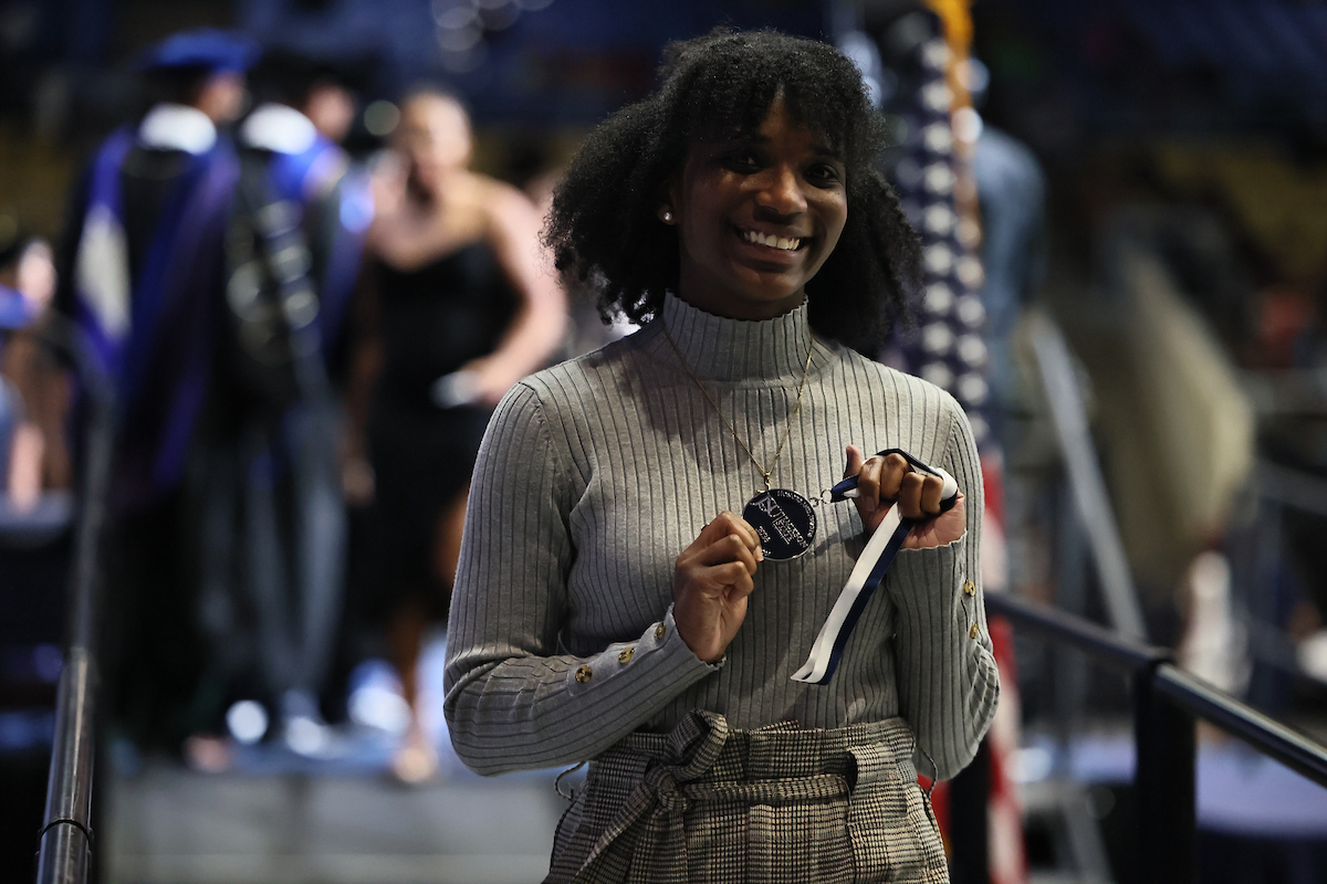 female student smiling with medal