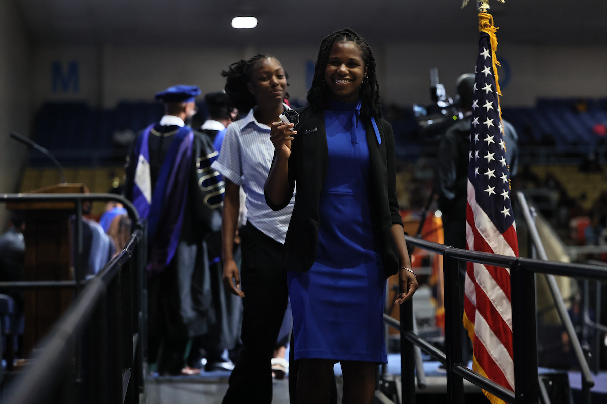 female student smiling with medal