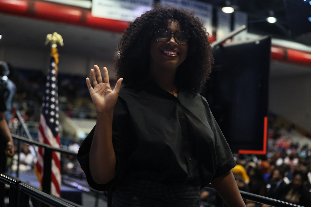 female student waving