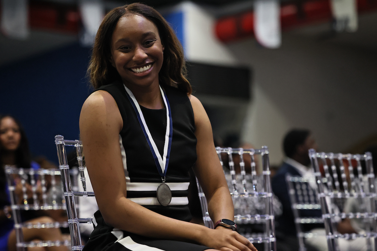 female student smiling with medal