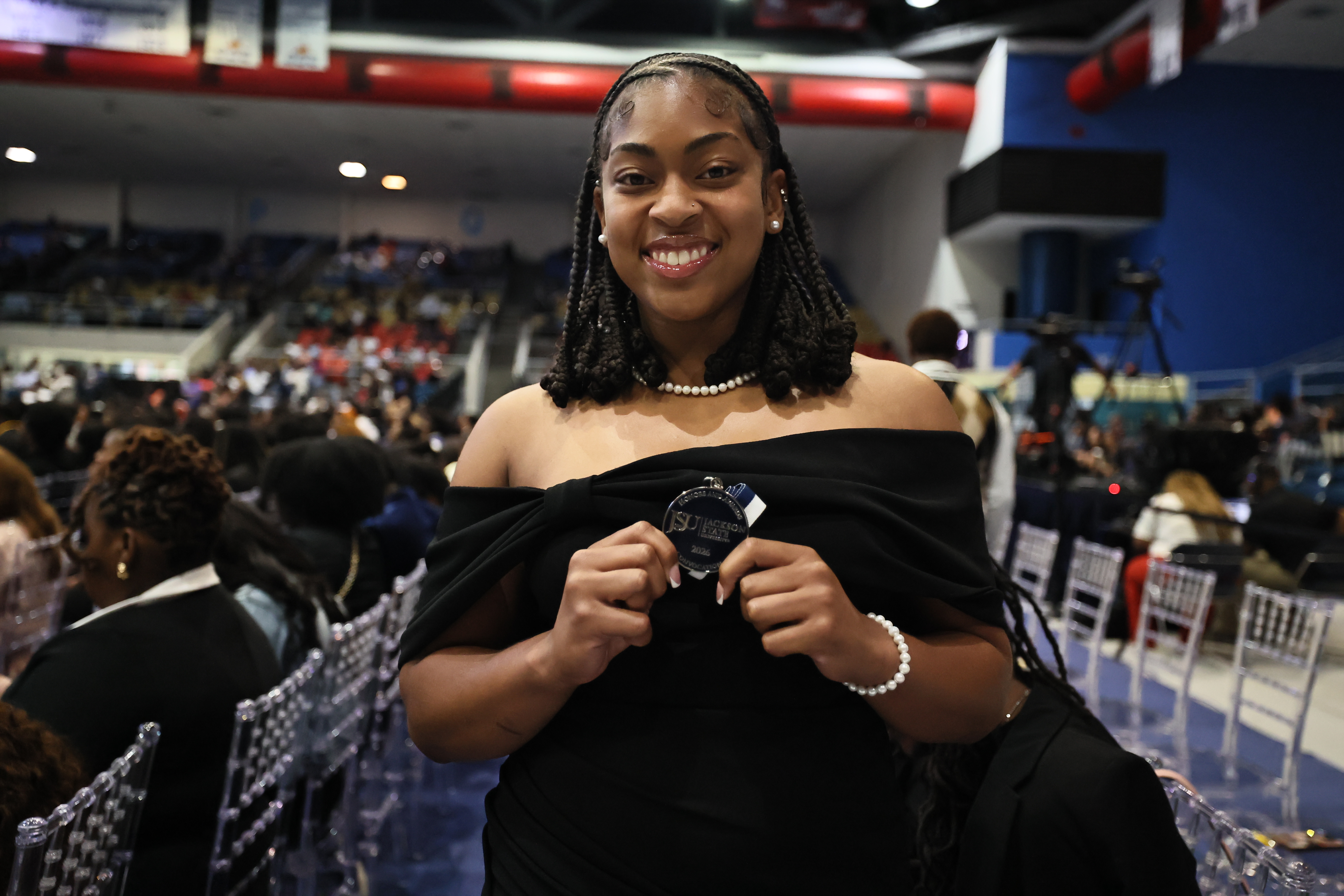 female student smiles with medal