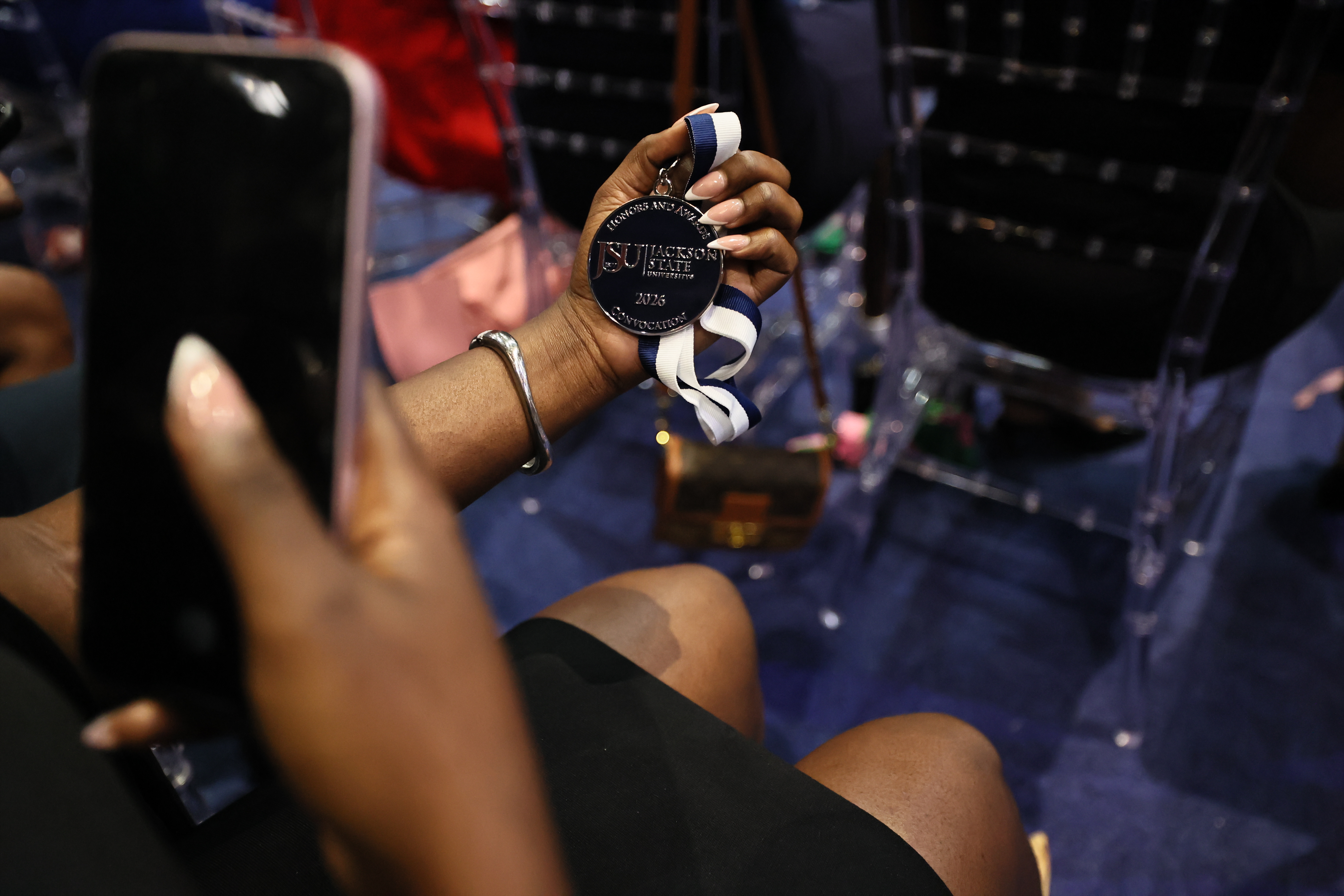 student takes photo of medal